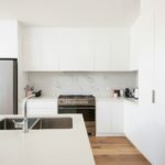 white wooden kitchen cabinet over white kitchen counter